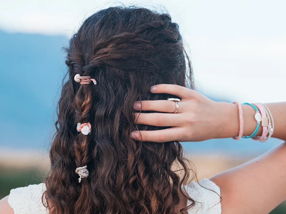 K'lani bracelets and shell jewelry worn to keep hair in check
