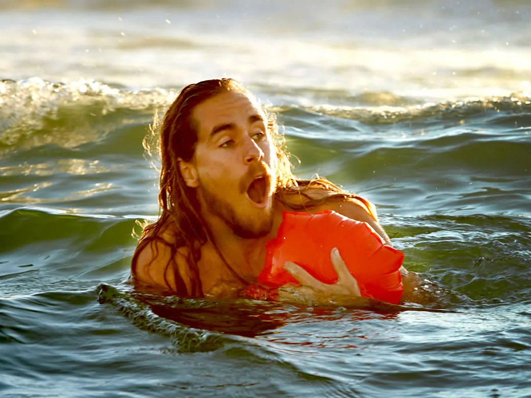 Man with Kingii wrist worn life preserver afloat in the ocean