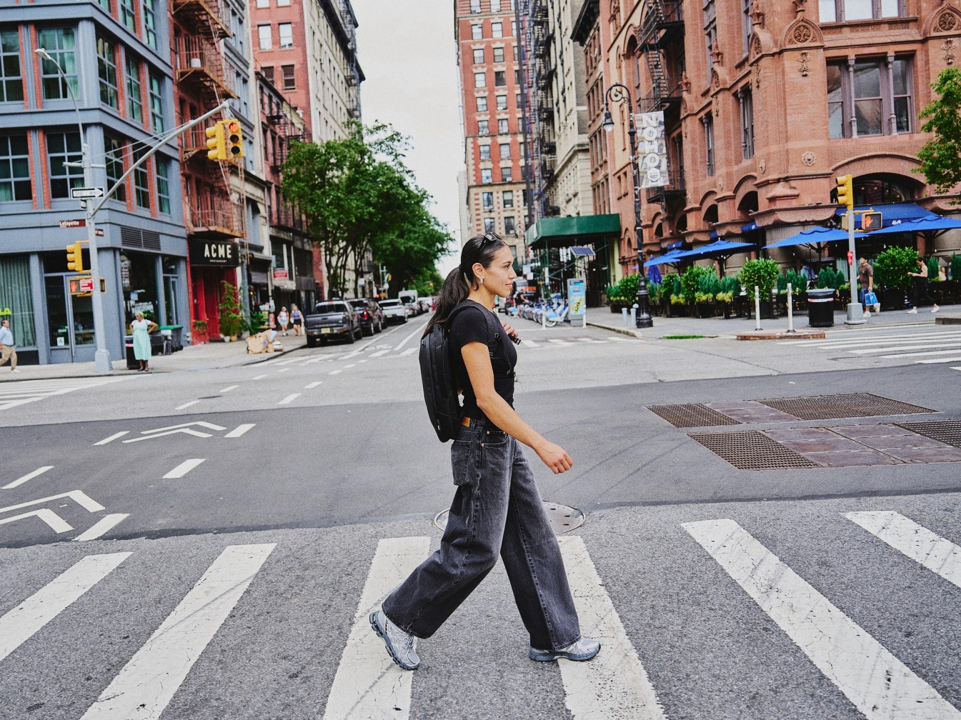 aer slim pack 2 worn on the back walking down the street