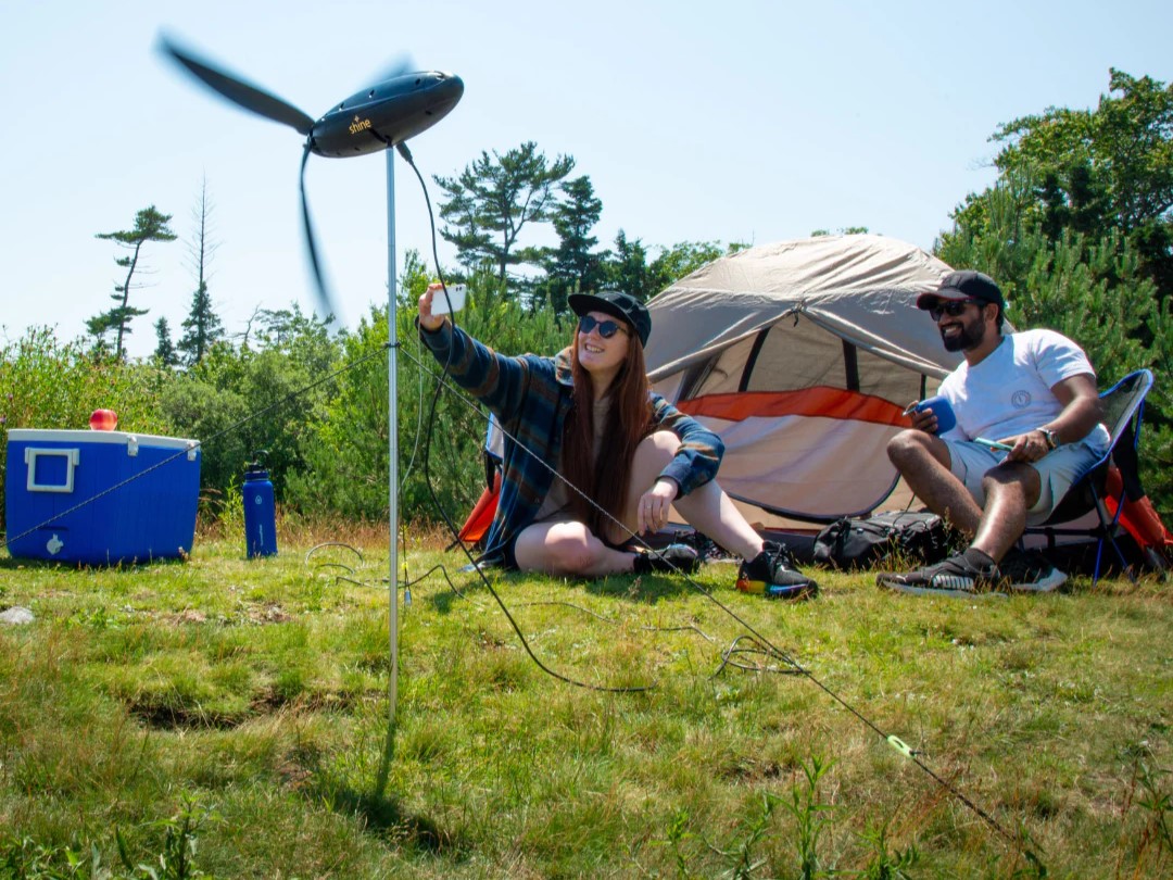 Shine portable wind turbine generating electricity at camp