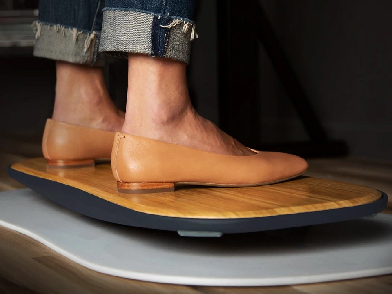 Someone standing on FluidStance balance board deck The Original