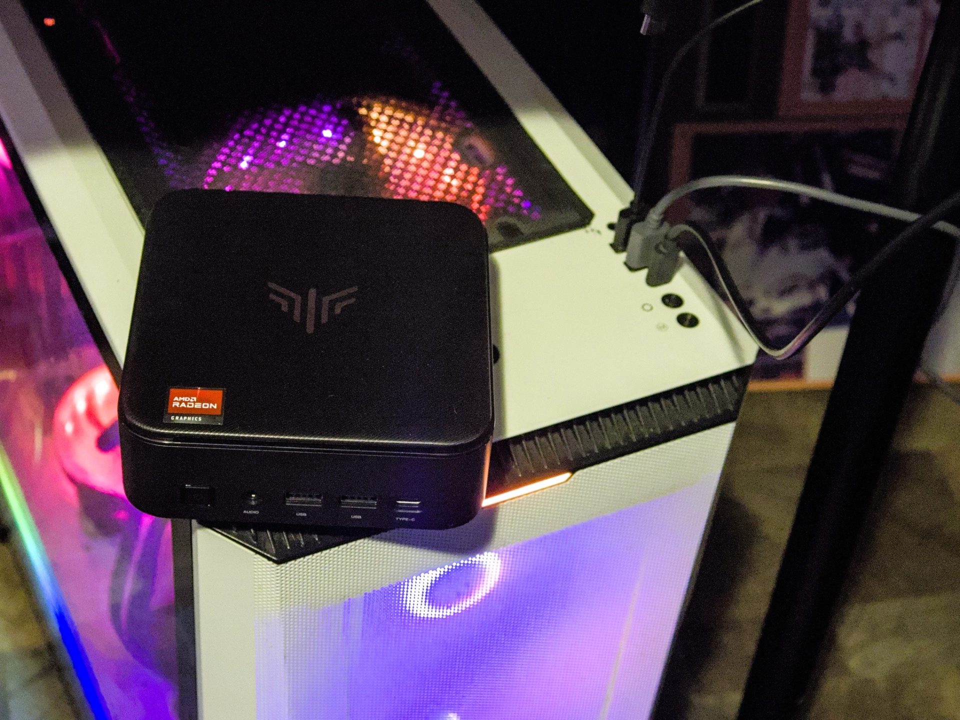 Kamrui E3B Mini PC resting atop full ATX tower desktop