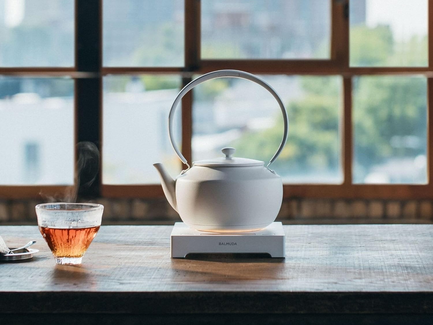 Balmuda MoonKettle smart electric kettle in a natural room with lighting