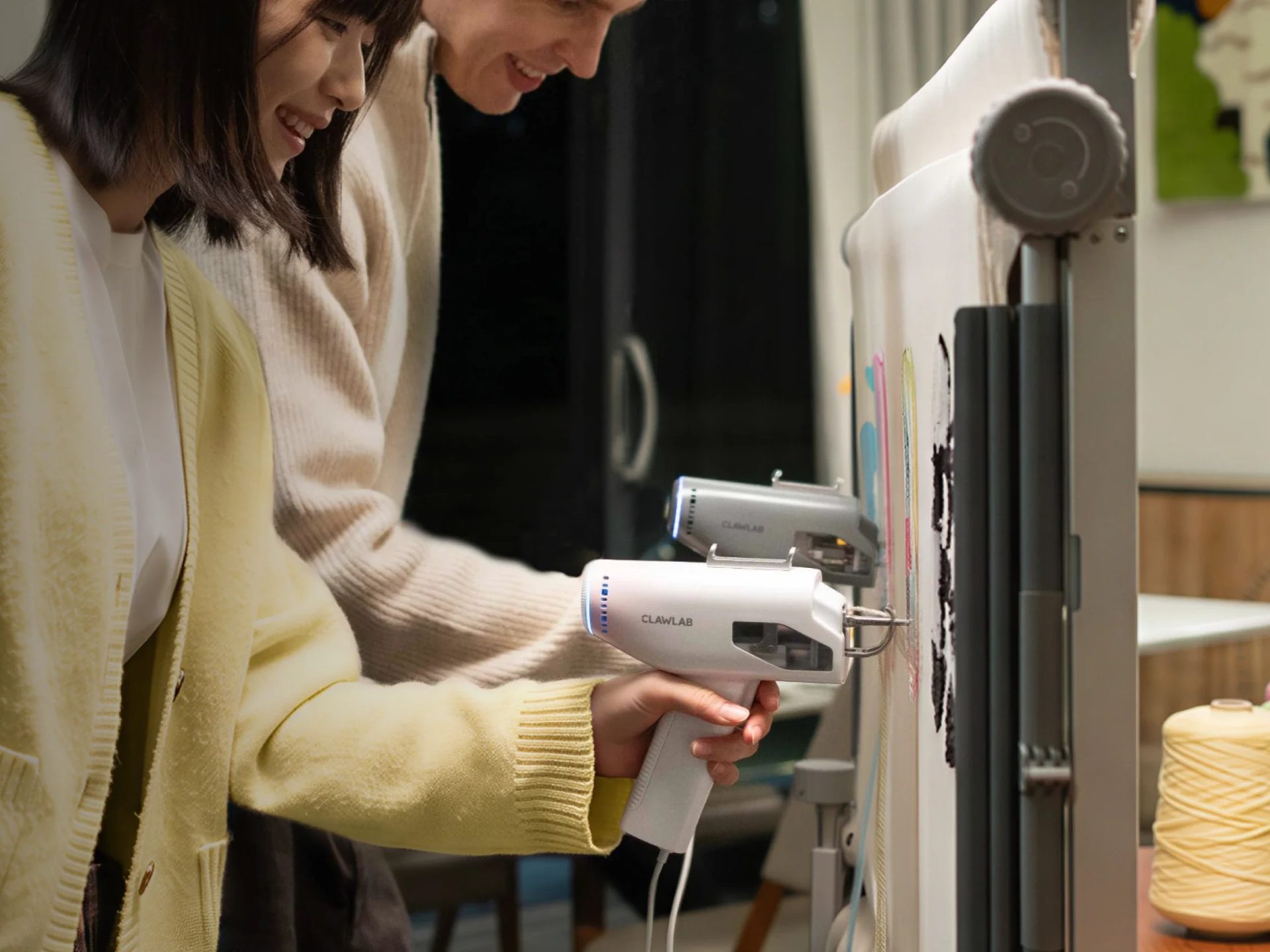 Clawlab H1 tufting gun in use to make yarn decorations