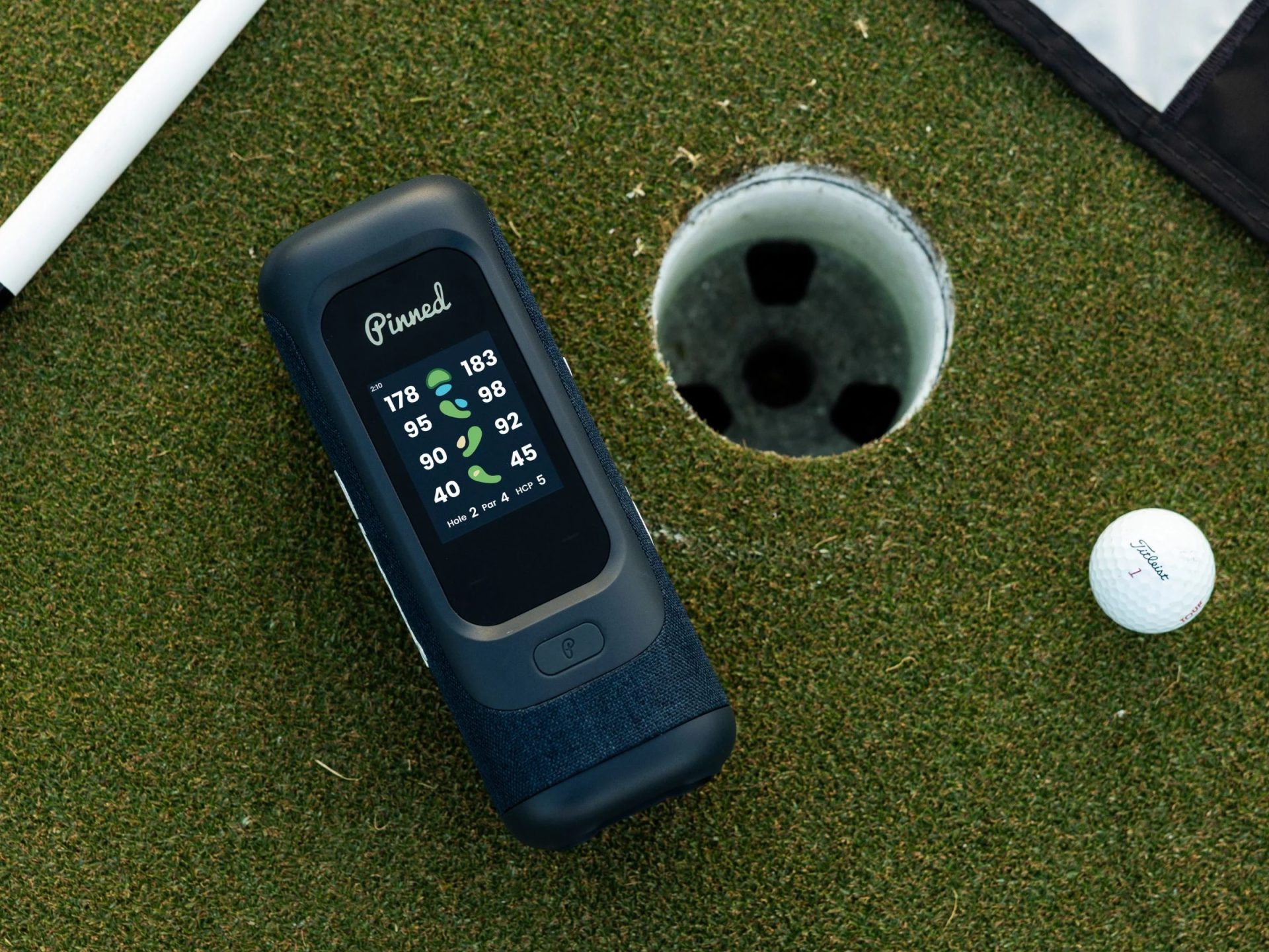 Sound Stick Pro magnetic Bluetooth speaker next to golf hole