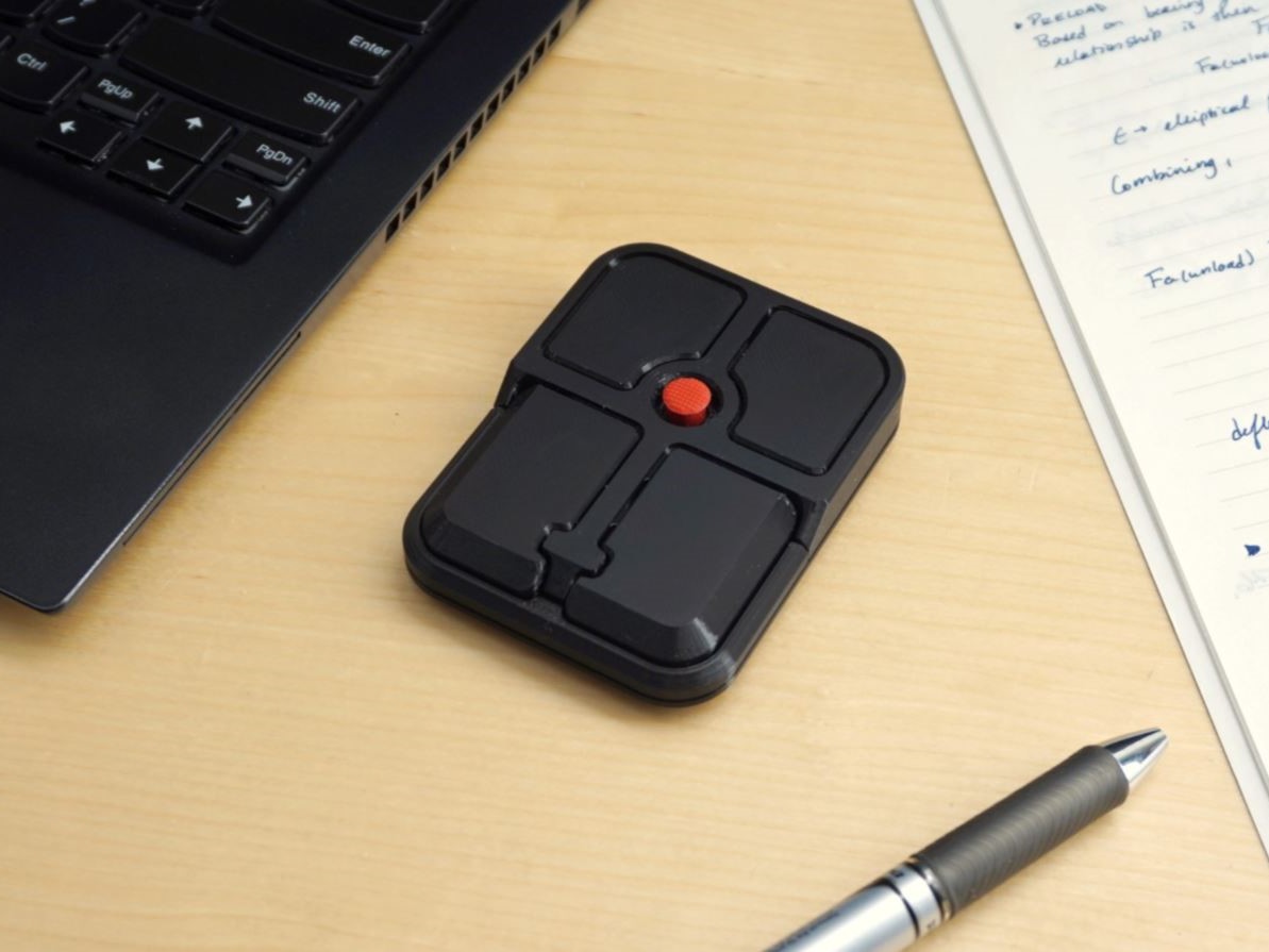 Ploopy Bean open source track point mouse on desk with notes and laptop